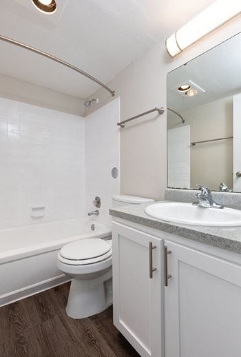 Bathroom with Wood Style Flooring and Tiled Shower with Tub